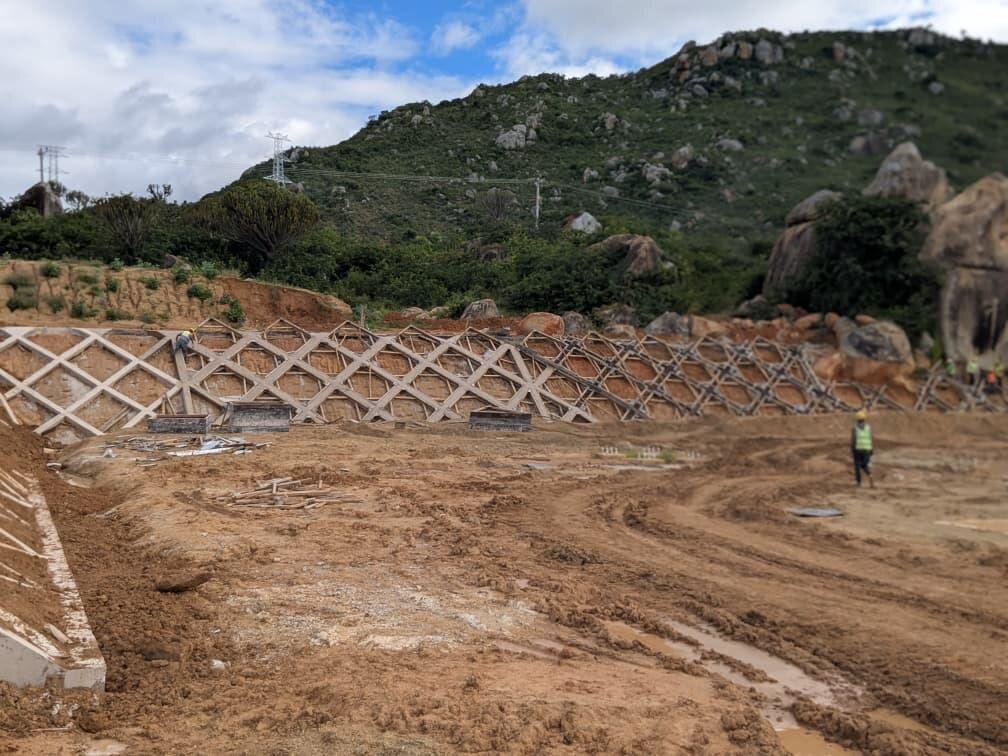Earthworks and retaining structures below a hillside